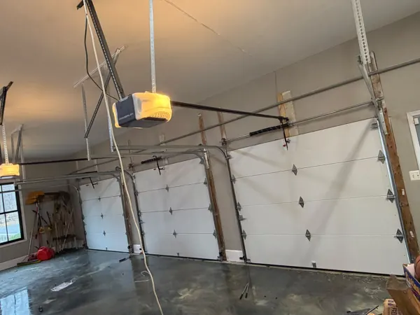 Inside a garage with new garage doors, tracks and a new opener installed
